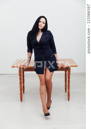 Portrait of teacher in black dress on light background Portrait of teacher in black dress on light background 125066567