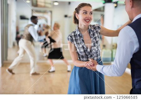 Man and woman performing jazz dance in dancing room 125066585