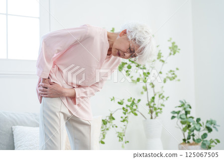 Senior women with low back pain 125067505