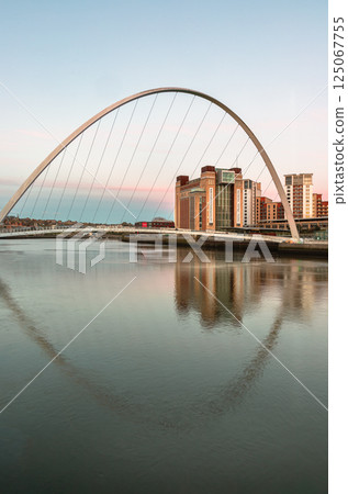 Beautiful scenery of The Iconic Gateshead millennium bridge spanning the River Tyne and Baltic flour mills with Magnificent sky in the background. 125067755