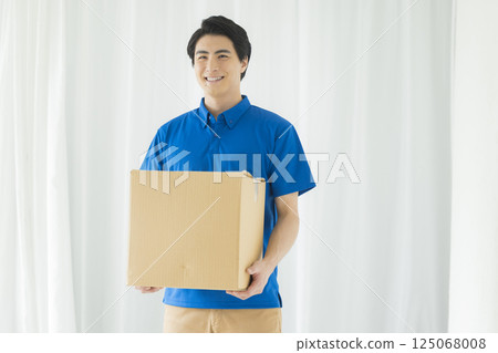 A man with a smile carrying baggage A man with a smile carrying baggage 125068008