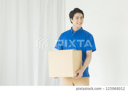 A man with a smile carrying baggage A man with a smile carrying baggage 125068012