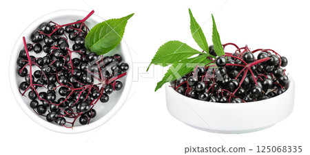 Ripe black elderberry or elder with green leaves in ceramic bowl isolated on a white background. Sambucus Ripe black elderberry or elder with green leaves in ceramic bowl isolated on a white background. Sambucus 125068335