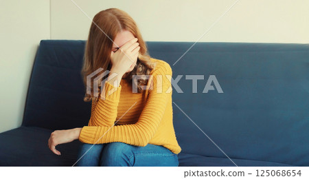 Upset sad crying woman while experiencing mental suffering, depression, fatigue, emotional stress Upset sad crying woman while experiencing mental suffering, depression, fatigue, emotional stress 125068654