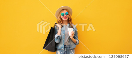 Shopping day! Stylish beautiful happy smiling young woman with black shopping bags, wear summer hat Shopping day! Stylish beautiful happy smiling young woman with black shopping bags, wear summer hat 125068657