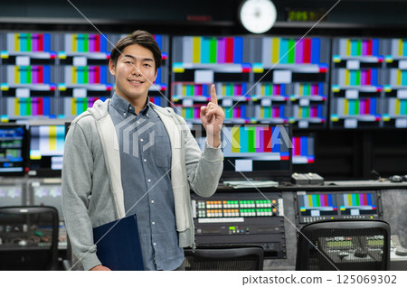 A young man producing video at a TV station. Filming cooperation: SKY Perfect TV Tokyo Media Center A young man producing video at a TV station. Filming cooperation: SKY Perfect TV Tokyo Media Center 125069302