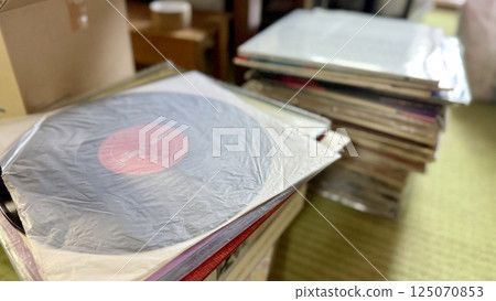 Records and stacks of record jackets 125070853