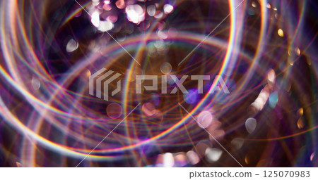 Magical disco. Defocused festive decoration. Multicolor shining attractive particles lens flare motion on blurred bokeh light background. 125070983
