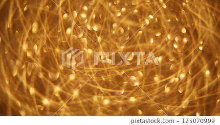 Christmas glimmering. Defocused holiday atmosphere. Blinking sparkling yellow colorful flickering circles motion on abstract bokeh light blurred background. Christmas glimmering. Defocused holiday atmosphere. Blinking sparkling yellow colorful flickering circles motion on abstract bokeh light blurred background. 125070999
