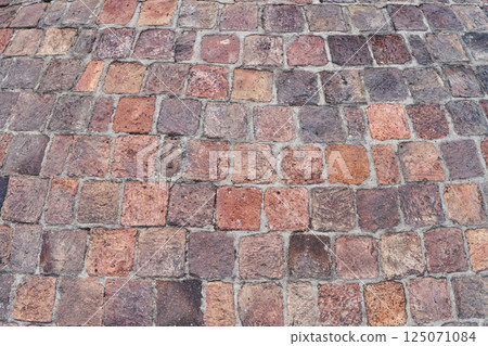 Old brick paving stones on the street background 125071084