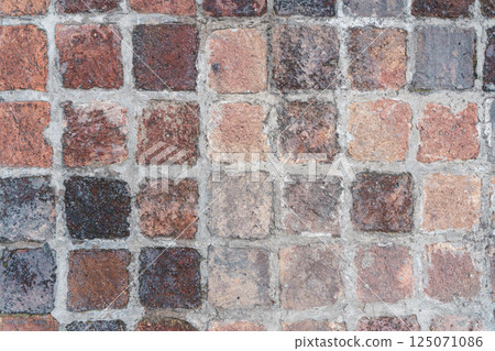 Old brick paving stones on the street background Old brick paving stones on the street background 125071086