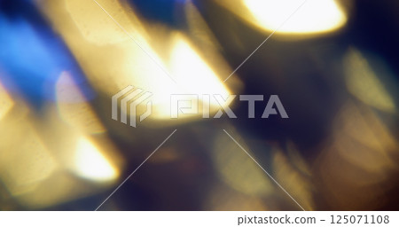 Abstract flare. Blur colorful glow. Defocused blue yellow golden lens texture magical light dawn on art dark black background. 125071108