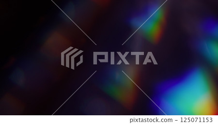 Glare texture. Blur rainbow. Defocused blue yellow green colorful sparkle dazzle gleam on abstract dark black art background. 125071153