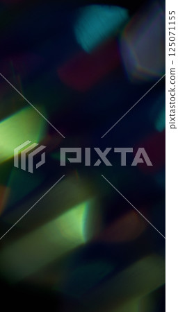 Shiny beam. Blur lens flare. Defocused blue yellow green colorful rainbow texture sparkle moving on abstract dark black background. Shiny beam. Blur lens flare. Defocused blue yellow green colorful rainbow texture sparkle moving on abstract dark black background. 125071155