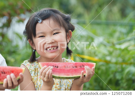 Child eating watermelon during summer vacation 125071208