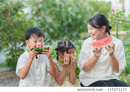 Parents and children eating watermelon during summer vacation Parents and children eating watermelon during summer vacation 125071215