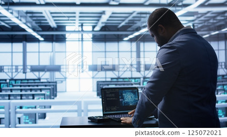 Artificial intelligence technology simulating human brain used by engineer in data center. Worker working on digital device with AI tech machine learning algorithms, camera B Artificial intelligence technology simulating human brain used by engineer in data center. Worker working on digital device with AI tech machine learning algorithms, camera B 125072021