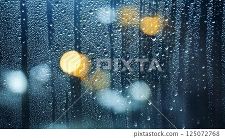 Water droplets on a window pane on a rainy day and blurred natural scenery Emotional background 125072768