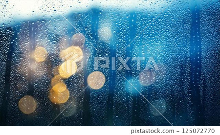 Water droplets on a window pane on a rainy day and blurred natural scenery Emotional background 125072770