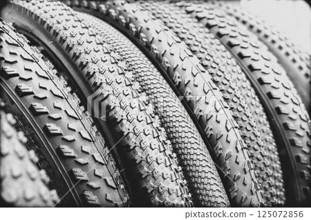Close-up of various bicycle tires showing different tread patterns 125072856