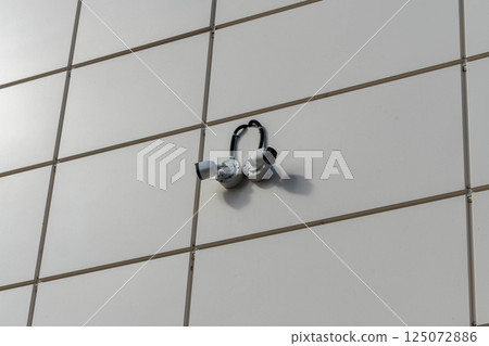 Security cameras observing building facade ensuring safety and surveillance 125072886