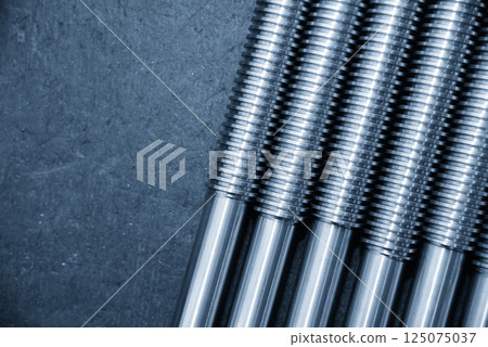 Closeup scene the spare parts lead ball screw shaft in the light blue scene. Closeup scene the spare parts lead ball screw shaft in the light blue scene. 125075037