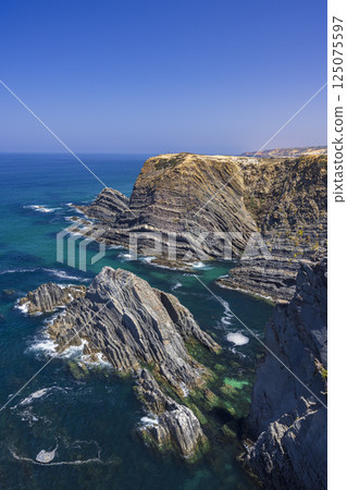 Stunning cliffs and turquoise waters of the atlantic ocean in odemira, portugal Stunning cliffs and turquoise waters of the atlantic ocean in odemira, portugal 125075597