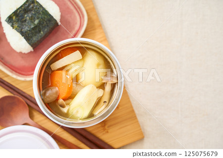 Hot miso soup and rice balls for lunch in a soup jar 125075679