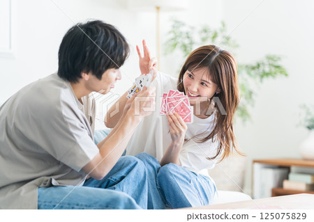 Couple playing with playing cards Couple playing with playing cards 125075829