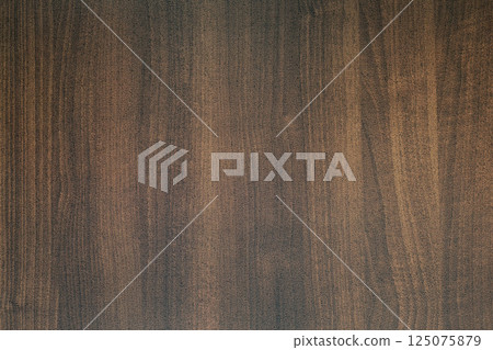 Dark brown wood grain texture background showing growth rings Dark brown wood grain texture background showing growth rings 125075879