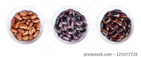 Three variations of scarlet runner beans in white bowls, isolated over white. Large seeds of dried runner beans, a variety of Phaseolus coccineus, also known as multiflora bean, butter, or fire bean. 125077726
