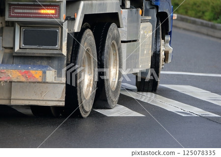 Image of a dump truck turning left at an intersection Image of a dump truck turning left at an intersection 125078335
