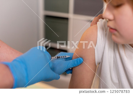 A Child Receiving Vaccination in a Safe and Professional Clinical Healthcare Setting 125078783