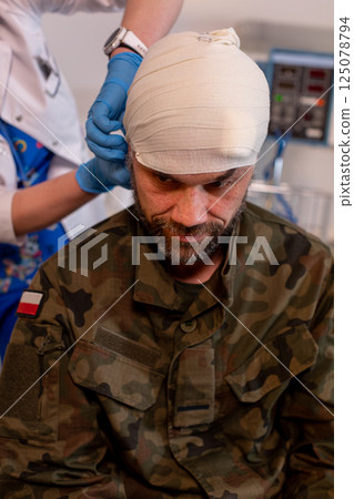 An Injured Soldier is Currently Receiving Essential Medical Treatment in a Combat Zone 125078794