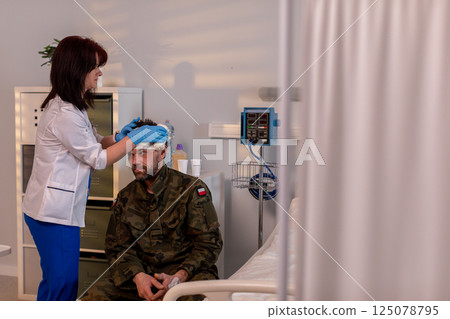 Military Personnel Accessing Vital Medical Care and Attention in a Hospital Environment Military Personnel Accessing Vital Medical Care and Attention in a Hospital Environment 125078795