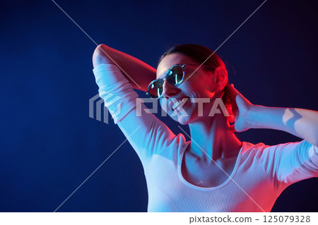 Young woman in underwear is in the studio with neon lights 125079328