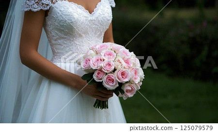 Woman holding a bouquet of pale roses 3 125079579