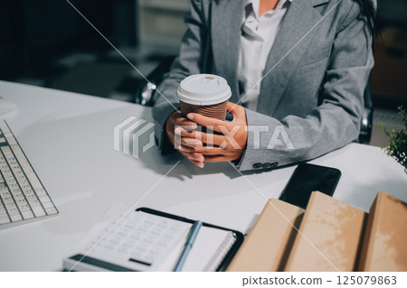 Portrait of Asian young female working on laptop at office 125079863