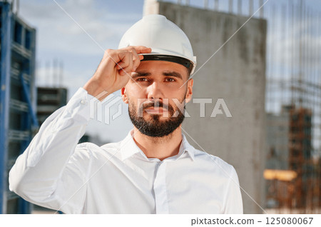 Portrait of man that is in uniform on the construction site 125080067