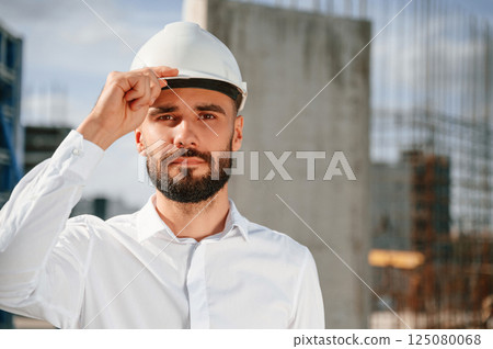 Portrait of man that is in uniform on the construction site 125080068