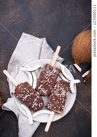 Coconut popsicles in chocolate glaze Coconut popsicles in chocolate glaze 125080111