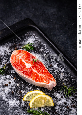 Raw uncooked salmon with rosemary Raw uncooked salmon with rosemary 125080132