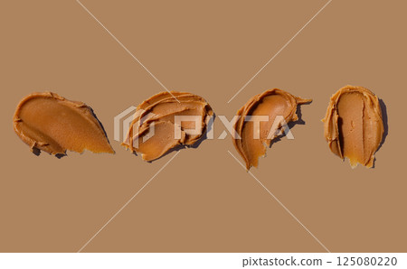 Smear of fresh peanut butter texture background 125080220