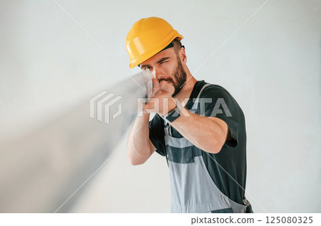 Holding construction material stuff by hands. The man is making repairs in the apartment Holding construction material stuff by hands. The man is making repairs in the apartment 125080325