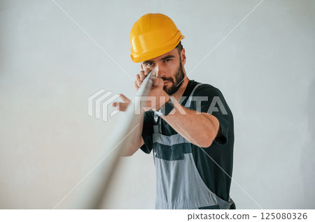 Holding construction material stuff by hands. The man is making repairs in the apartment Holding construction material stuff by hands. The man is making repairs in the apartment 125080326