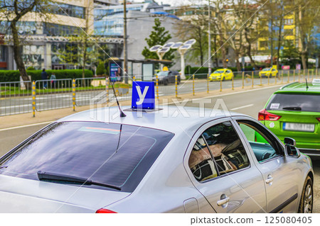 Car with Driving school blue sign on roof used in Bulgaria. Sign training vehicle. Learning driving skills in driving school. Concept of driver license, traffic rules 125080405
