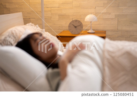 A young woman sleeping in bed A young woman sleeping in bed 125080451
