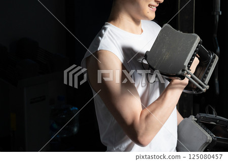 Man doing muscle training with dumbbells 125080457