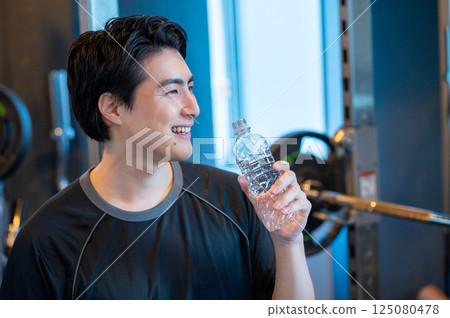 Man drinking water at the gym Man drinking water at the gym 125080478