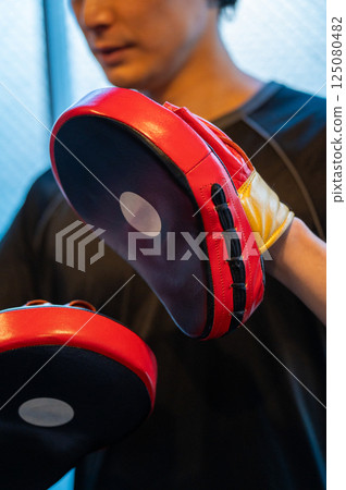 Young man holding a mitt Young man holding a mitt 125080482